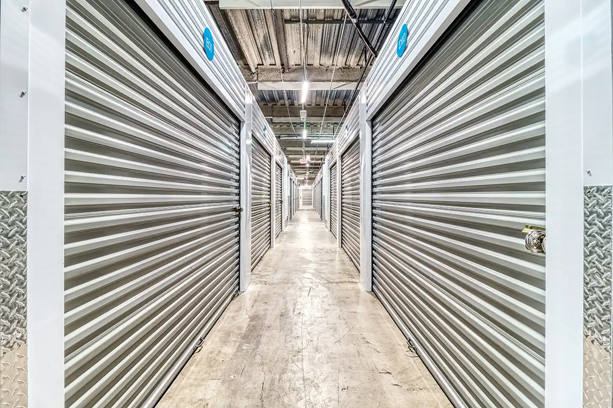 Indoor hallway of clean, climate-controlled storage units at MyPlace Self Storage, featuring well-lit corridors and secure roll-up metal doors.